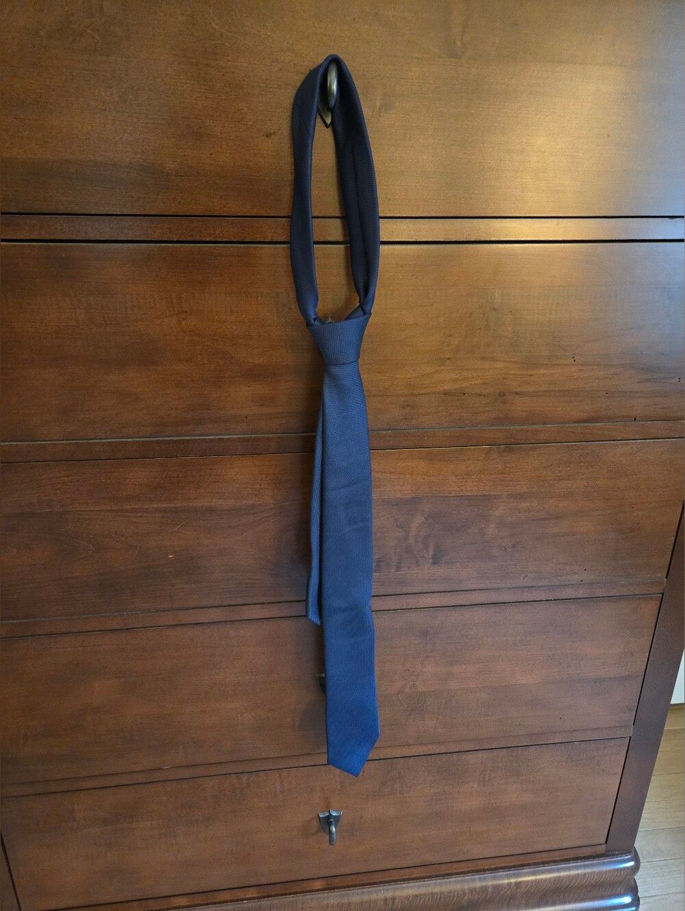 Classic navy men's tie with some subtle patterning.